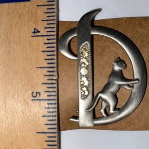 “D” pin with rhinestones and a CAT.